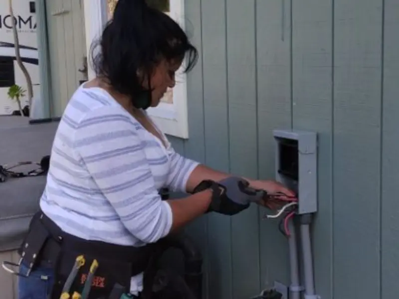 Licensed electrician wiring an exterior subpanel in Ward